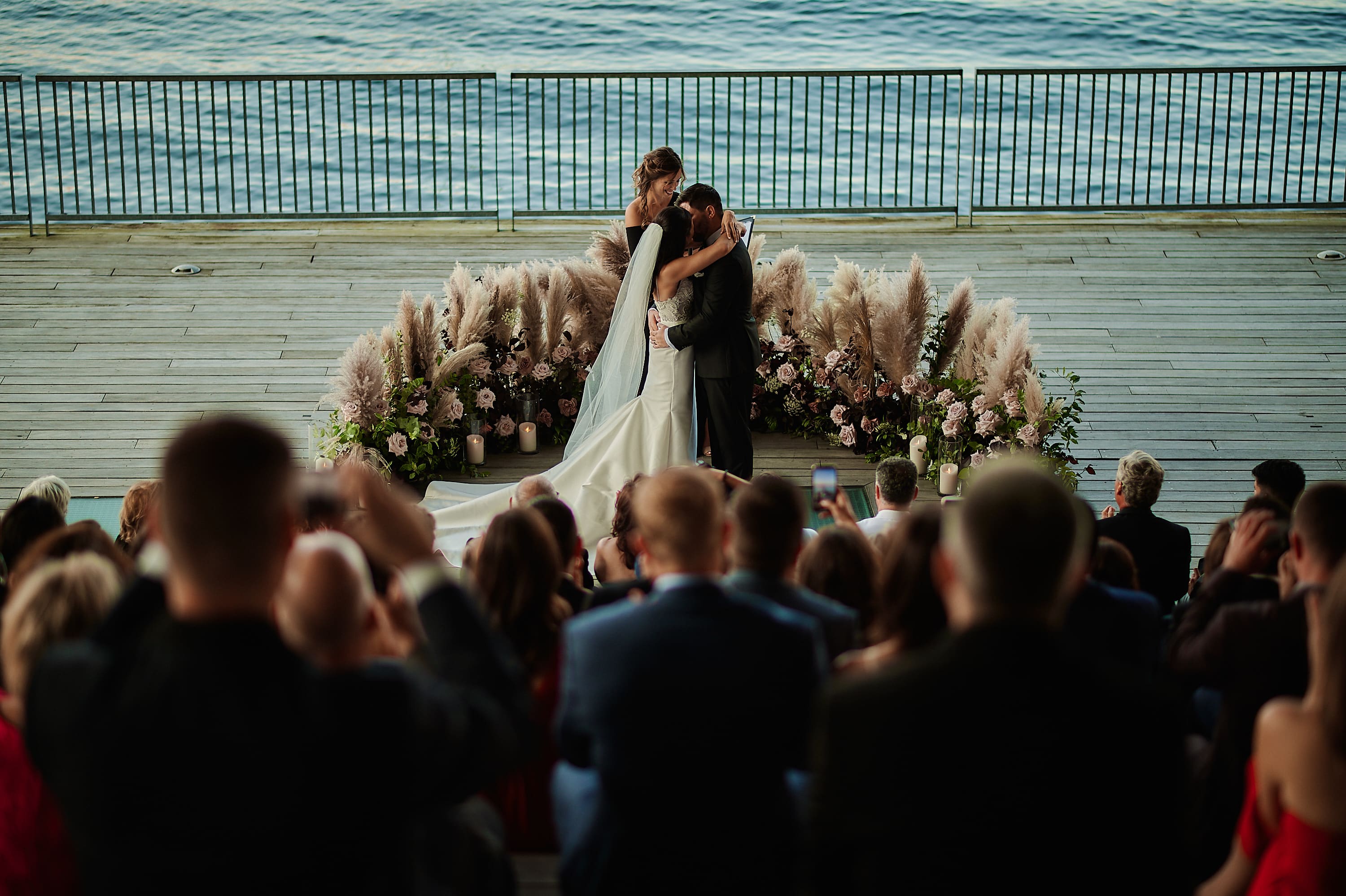 Romantic kiss during a waterfront wedding ceremony in Boston